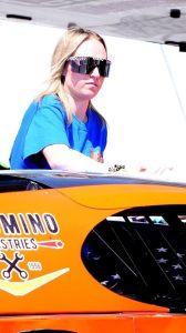 Savannah Seely looking over the top of race car.